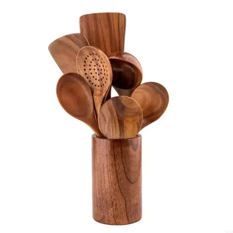Set of wooden spoons in a wooden holder on a white background