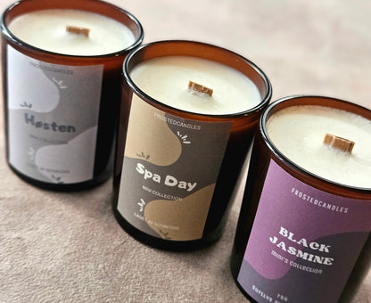 Mini Høsten soy candle in a tin with a maple wood wick and autumn leaf background