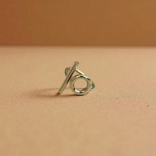 Silver ring with a unique design on a beige background