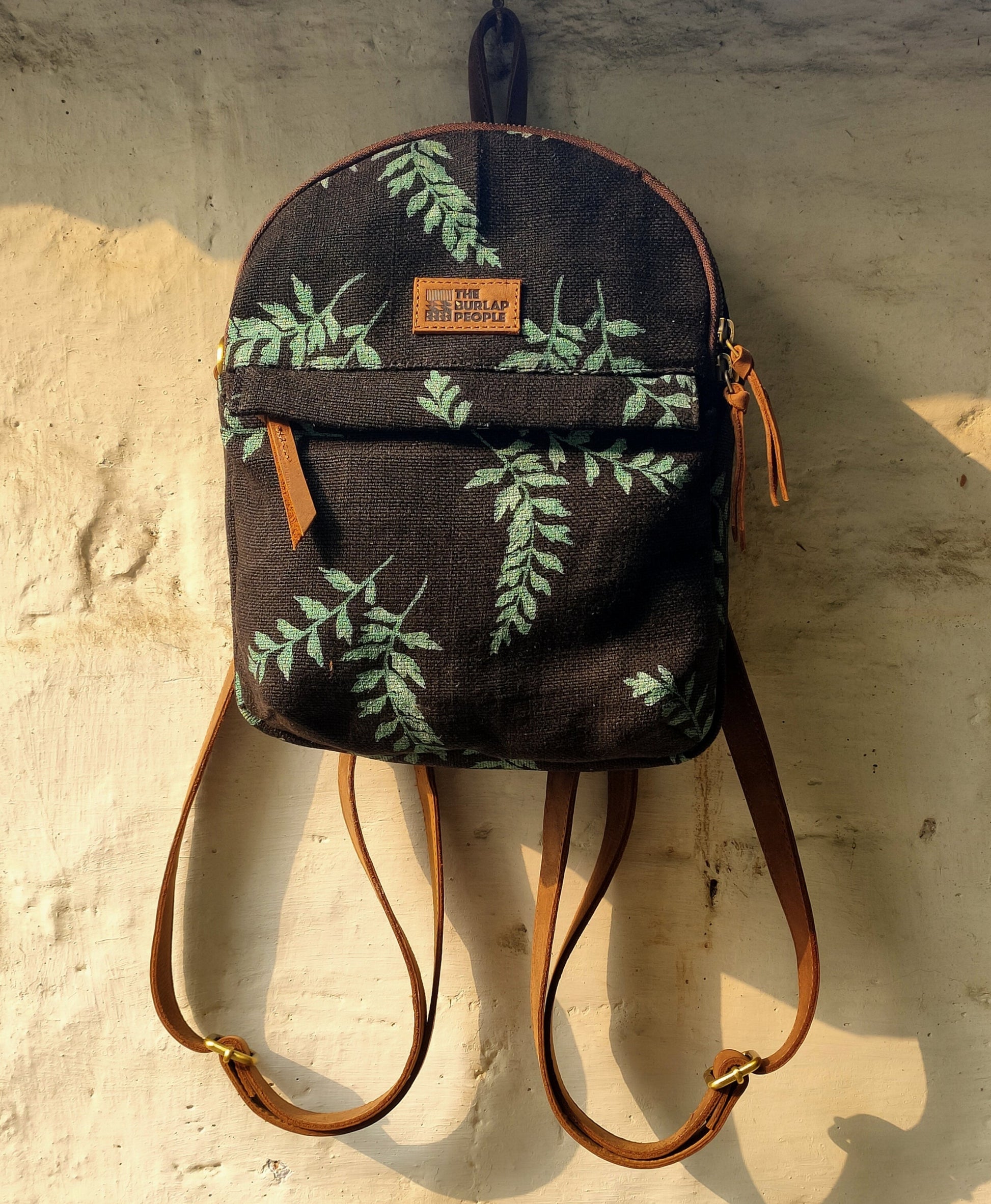 Convertible Lil Sister bag in sustainable jute shown as both a mini backpack and crossbody sling by Kalaa.