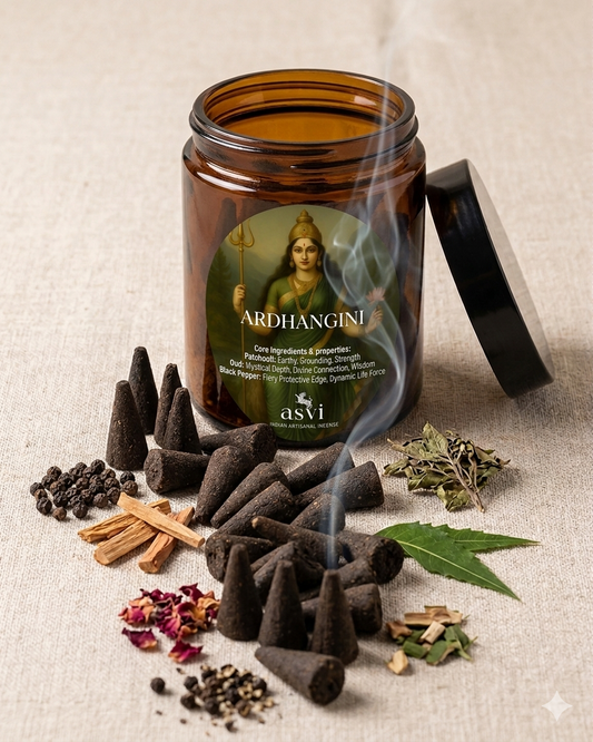 Ardhangini incense jar with smoke, surrounded by incense cones and herbs on a textured surface.