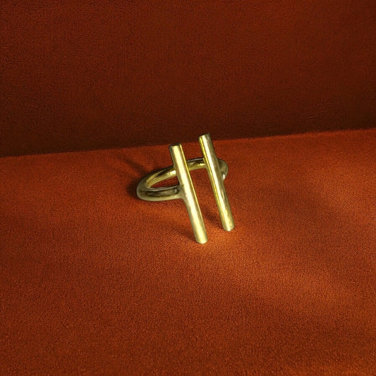 The Wili minimalist brass ring by Oriaku Studio, featuring a unique dual-bar design symbolizing balance.