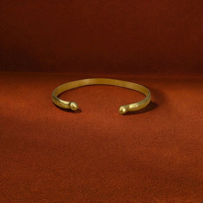Gold bracelet on a red fabric background