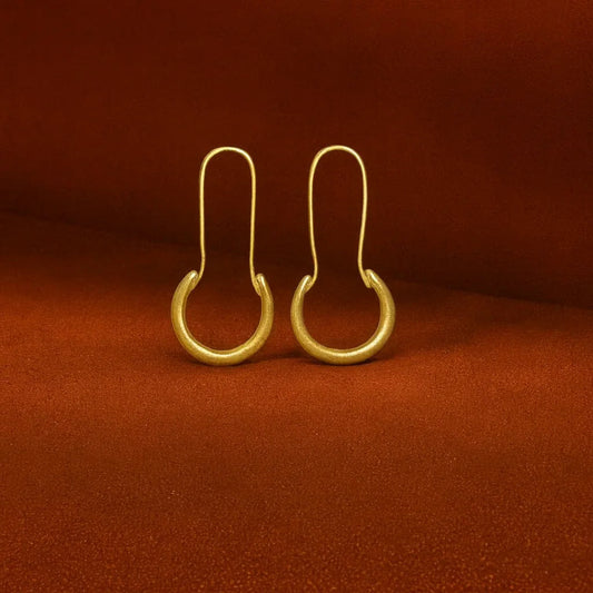 Editorial shot of the Suma brass earrings by Oriaku Studio, showcasing their modern African design.
