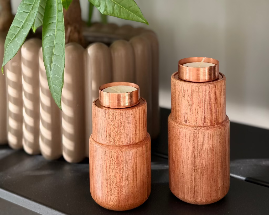 The Stambha reversible candle holder featuring a hand-spun copper top and a sustainable wooden pillar base.