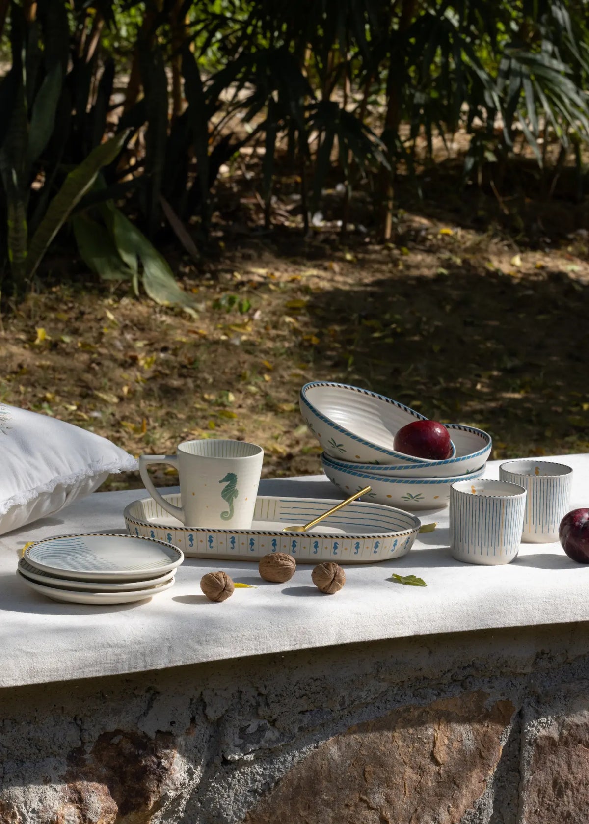 Set of ceramic dishes on a stone surface with a natural background