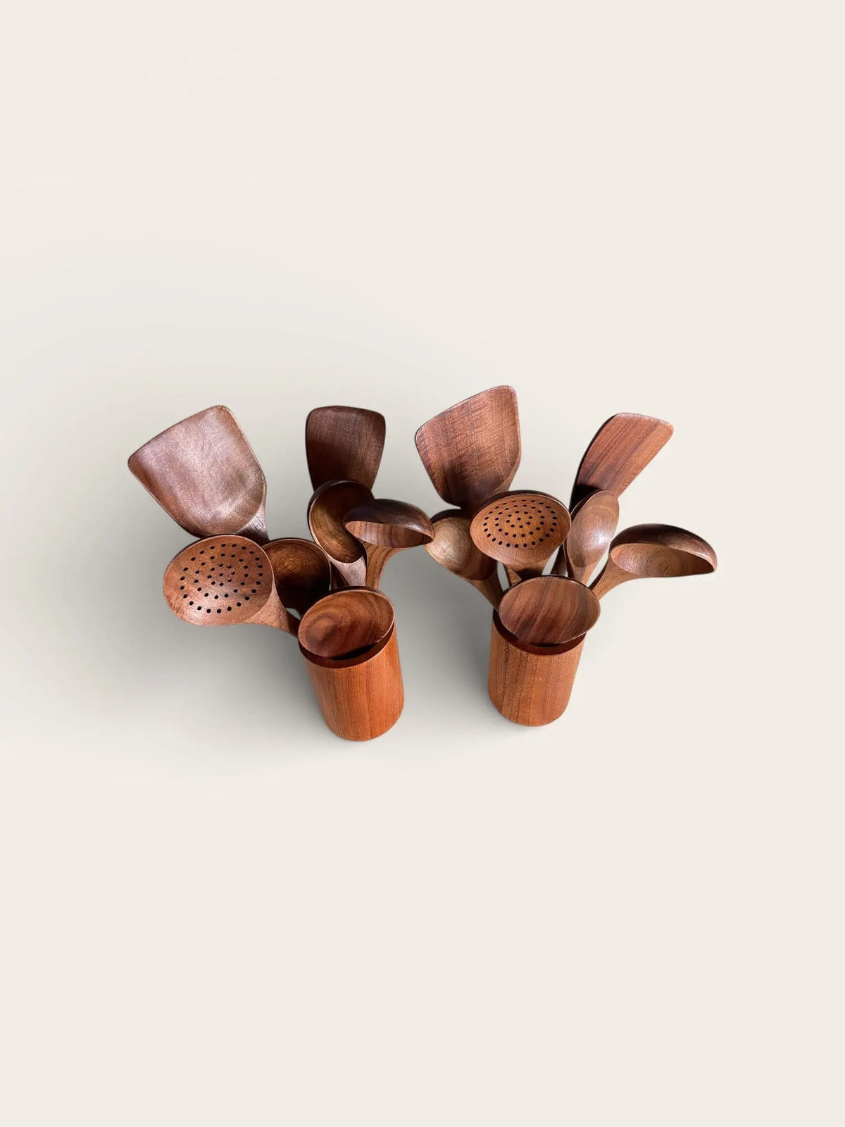 Wooden tea infusers on a light beige background