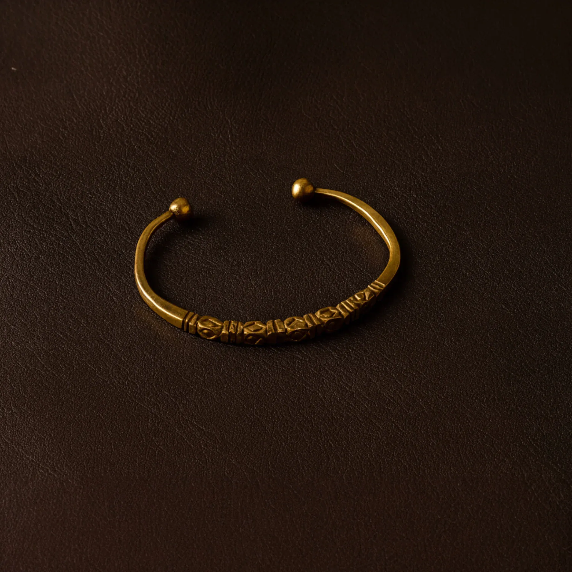 Bronze bracelet on a dark brown background