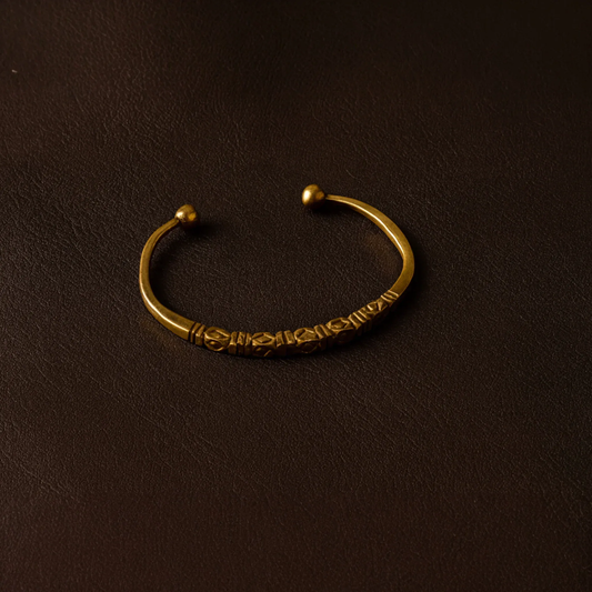 Bronze bracelet on a dark brown background