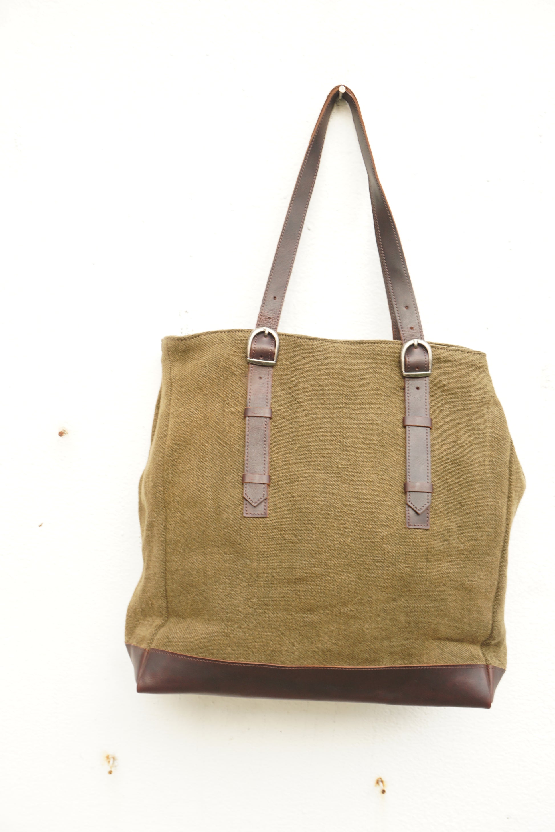 Brown bag with leather straps on a white background