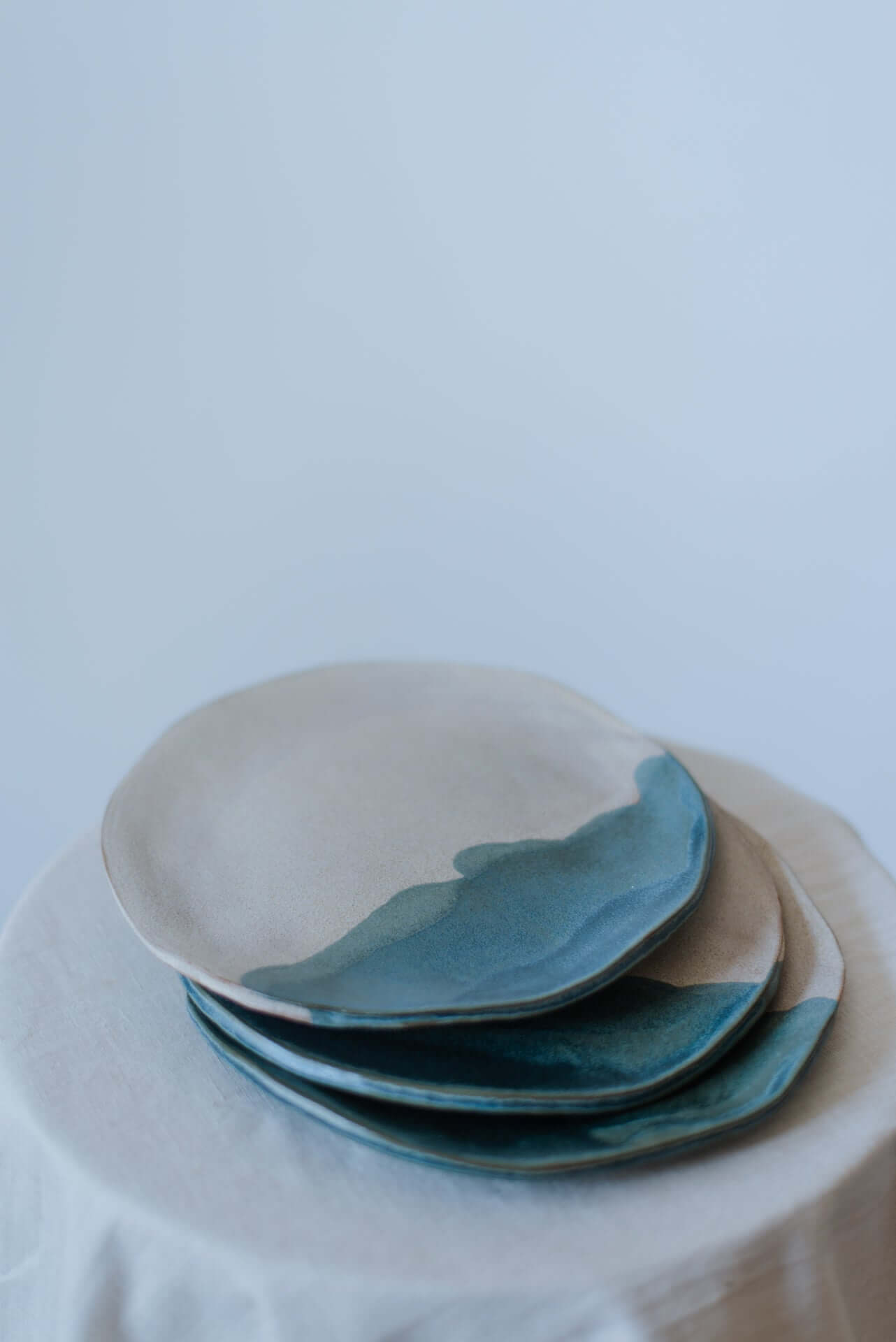 Handcrafted coupe plate with a smooth, glazed finish, ideal for serving meals or breakfast